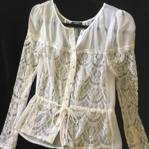 A sheer XS white long sleeve blouse.